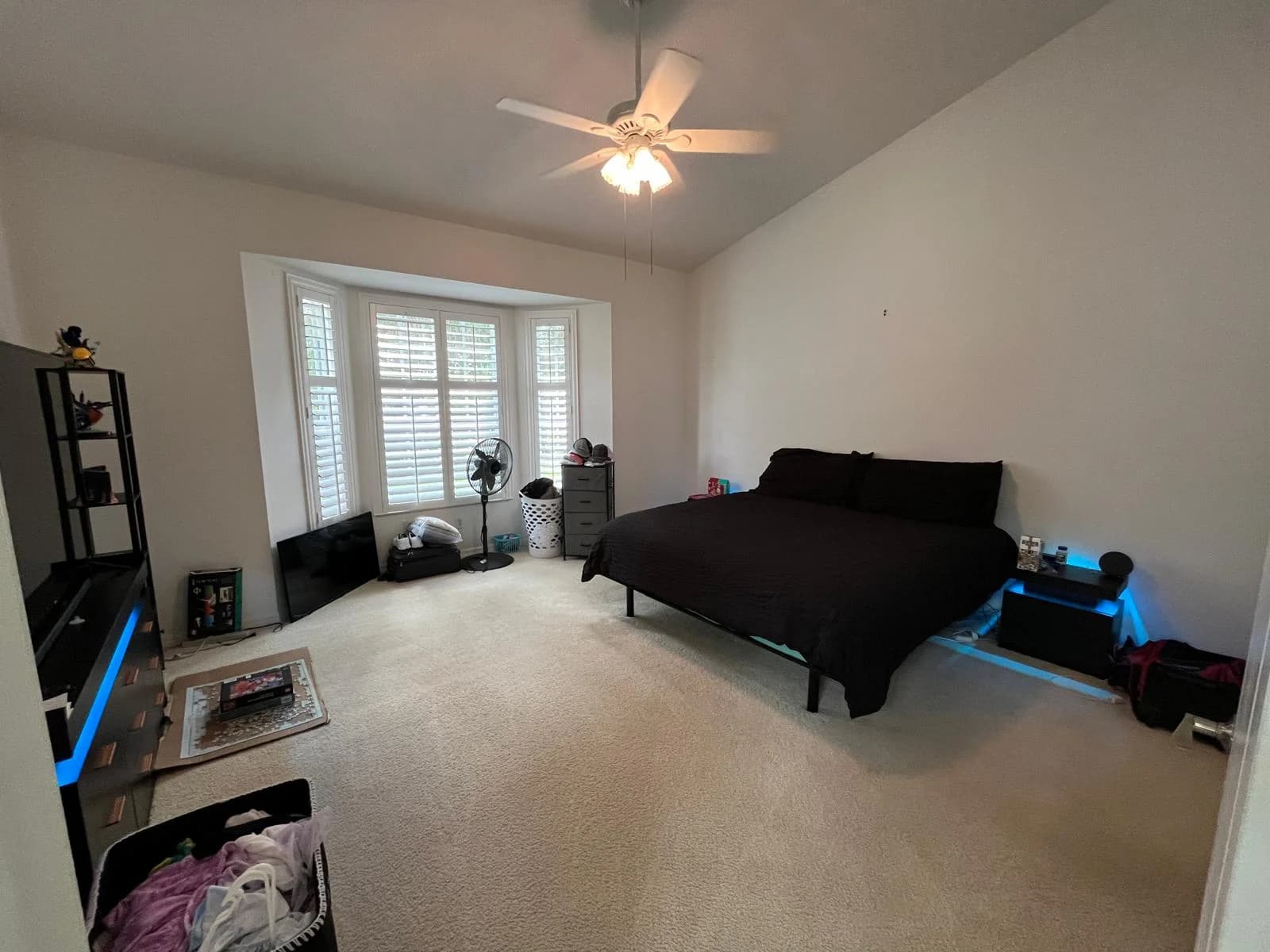 A tidy bedroom, carpet vacuumed and surfaces dusted.
